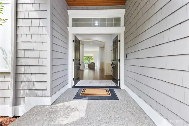 Step into a light-filled foyer with soaring ceilings and timeless elegance.