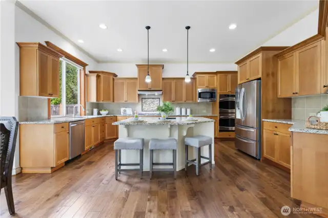 Oversized kitchen island anchors this gourmet chef’s kitchen.