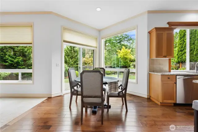 Sunny breakfast nook with views of the backyard and open space beyond.