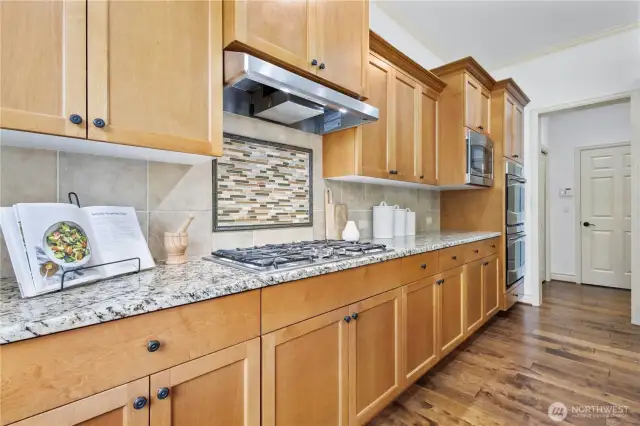 Stainless steel appliances and a 5-burner gas cooktop for serious culinary inspiration.