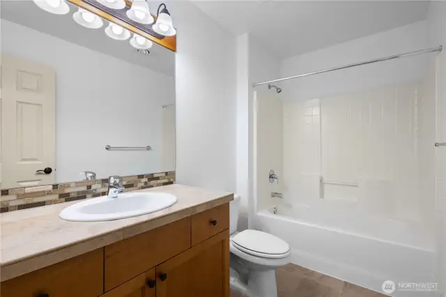 Full bath with tub/shower combo.