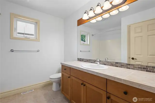 Full bath with tub/shower combo.