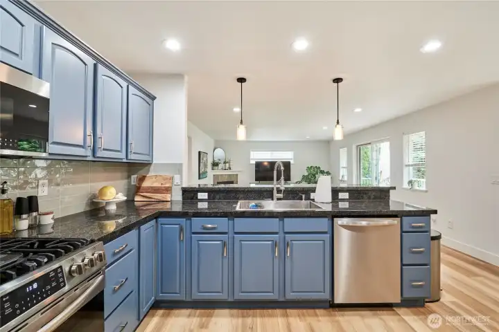 The "breakfast bar" (on the other side of the sink) defines the space between the kitchen and the living room and also seats 3 people.