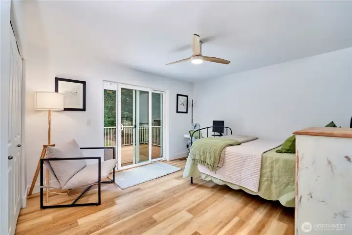 The second bedroom is very spacious and offers hardwood flooring, ample closet space and a sliding door to the back deck.