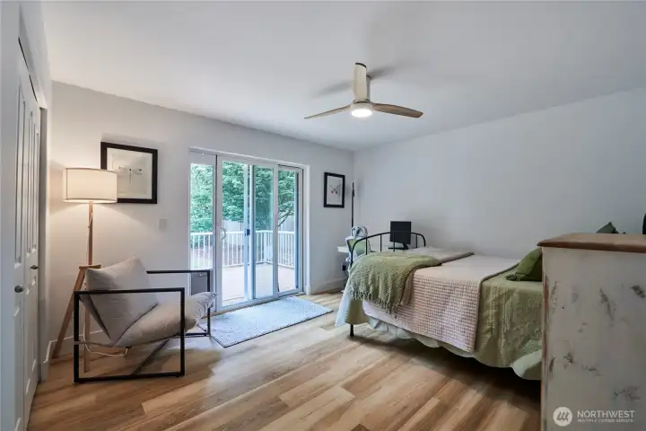 The second bedroom is very spacious and offers hardwood flooring, ample closet space and a sliding door to the back deck.
