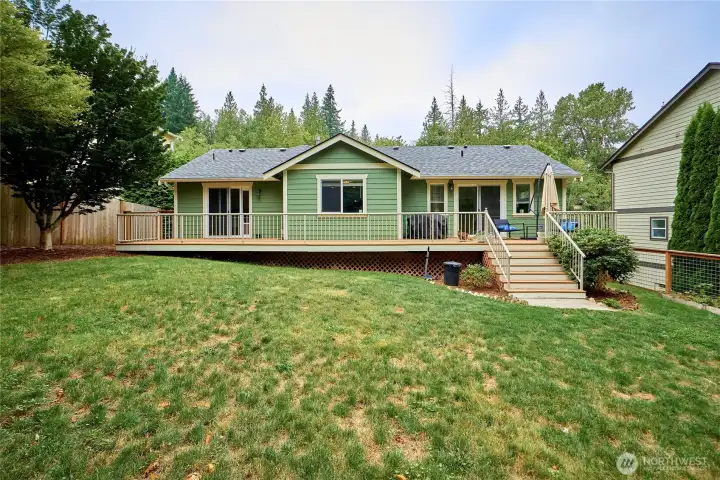 A look back at the home from the back yard. A new roof was installed a few years ago. Note that sliders off the living room and the 2nd bedroom create 2 distinct outdoor "rooms" on the deck!