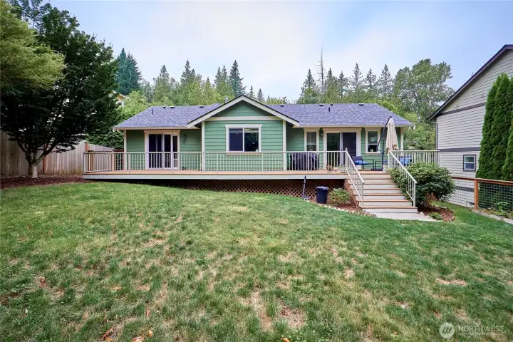 A look back at the home from the back yard. A new roof was installed a few years ago. Note that sliders off the living room and the 2nd bedroom create 2 distinct outdoor "rooms" on the deck!
