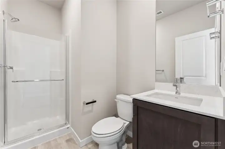 Downstairs bath features a walk-in shower. Pictures are for representational purposes only, colors and features may vary.