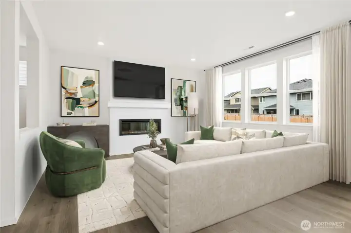 Cozy up by your electric fireplace in your great room with large windows. Virtual Staged.