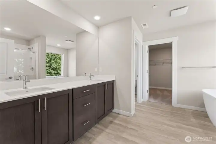 Double sink in the primary bath with quartz countertops. Primary bedroom big enough for a king or cali king bed. Pictures are for representational purposes only, colors and features may vary.