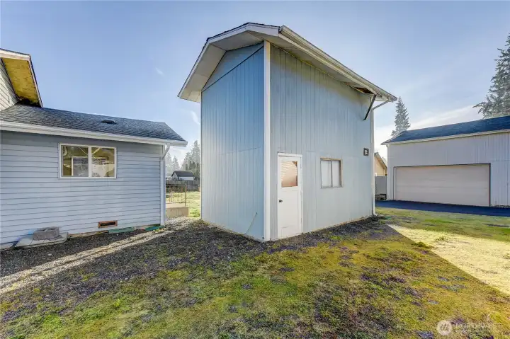Back of house with room to build an addition. 1 car garage with storage loft