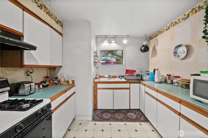 As you enter the home, the efficient kitchen is on your left. Plenty of counterspace for your cooking needs and a gas stove.