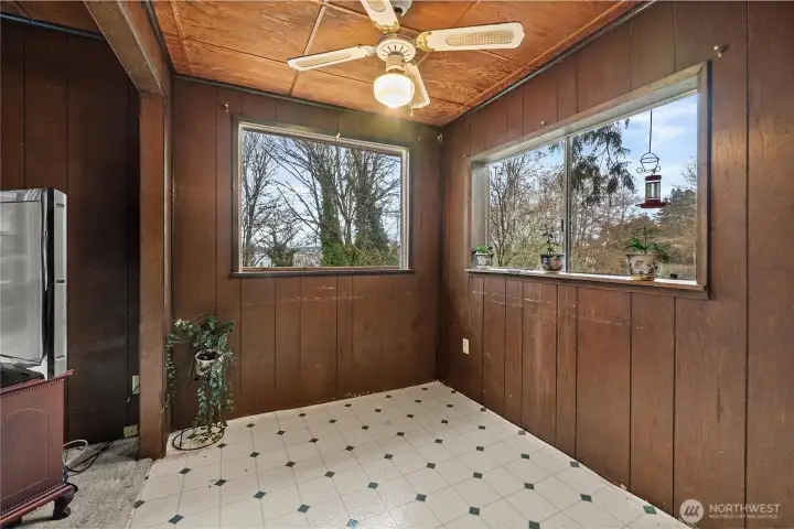 Classic wood walls and ceilings make this space feel cozy, with plenty of windows to enjoy the view from.