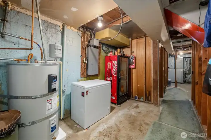 Straight down the hall from the bonus room has this open storage area. Newer water heater! Freezer and Coca-Cola fridge can stay!