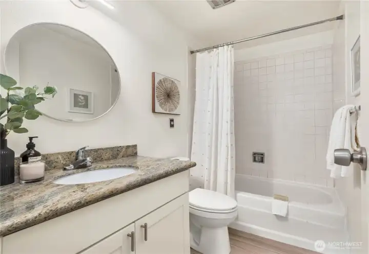 Second bathroom with granite countertop.