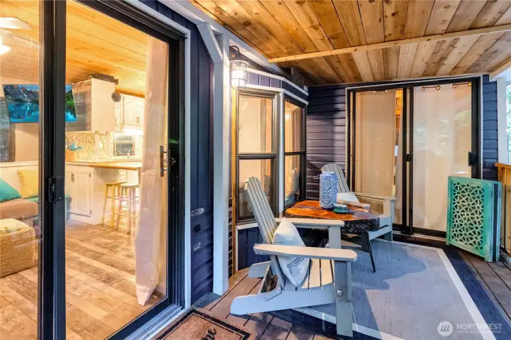 Close-up of covered deck with seating and access to interior