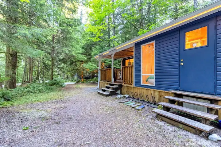 Side exterior showing extended structure and wooded setting