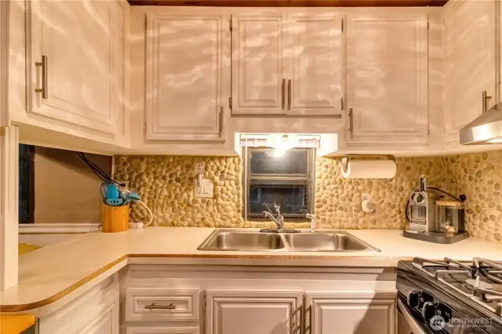 Kitchen sink and prep area with ample storage