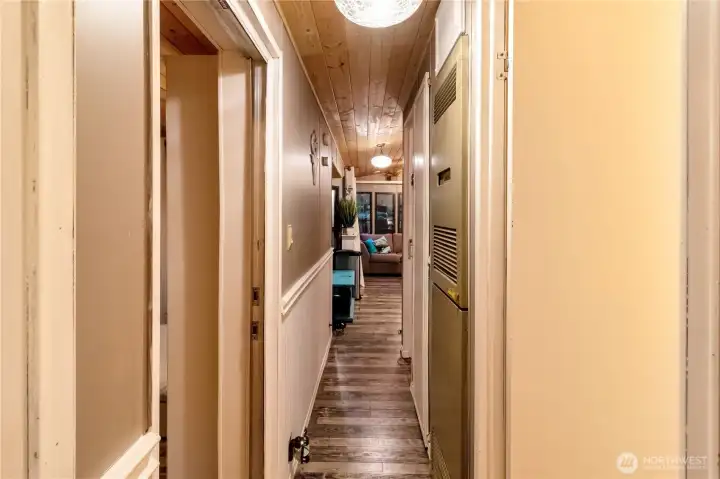 Hallway connecting living space to bedrooms and bath