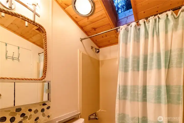Bathroom with tub/shower combo, vanity, and wood ceiling detail