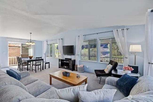 Spacious living room opens to dining room