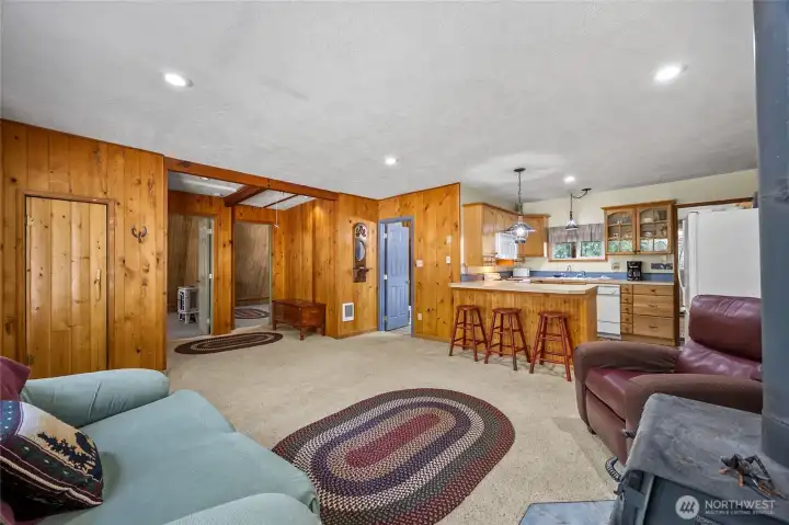 Bright and comfortable living area with large windows overlooking the tranquil, wooded surroundings.