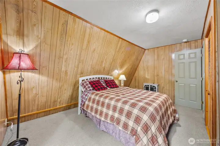 Inviting bedroom retreat with natural light and peaceful surroundings in this Packwood mountain getaway.