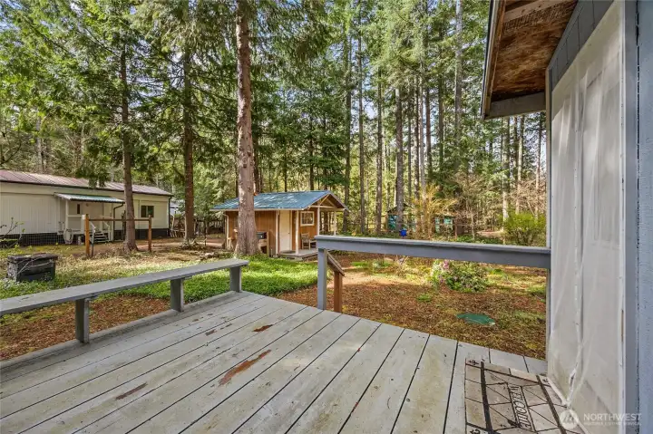 Private back deck overlooking a serene wooded lot—enjoy the peaceful High Valley setting in Packwood, WA.