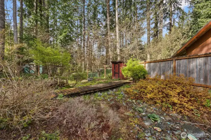 Private backyard with garden space and firepit potential—perfect for creating an inviting outdoor experience for Airbnb guests.