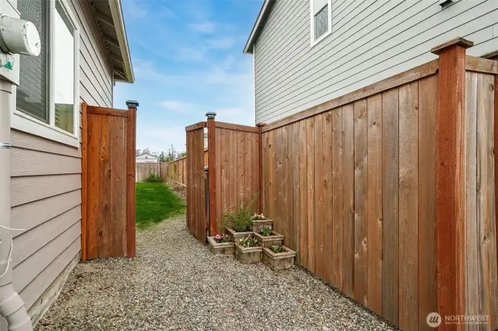 Side garden area that leads into the back yard
