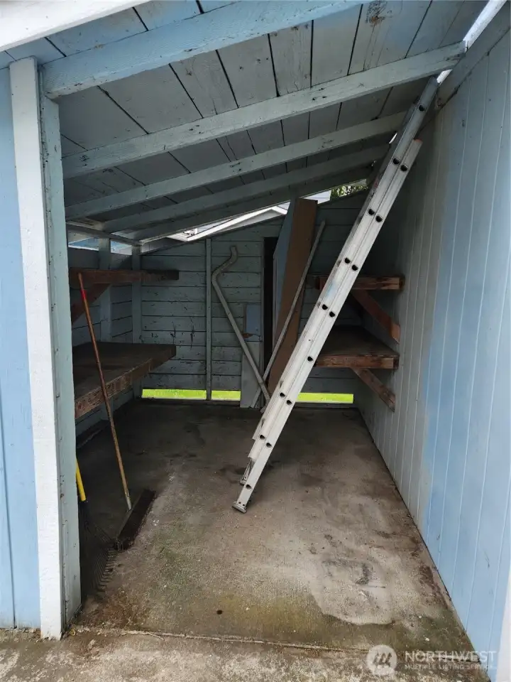 Covered area attached to shop.