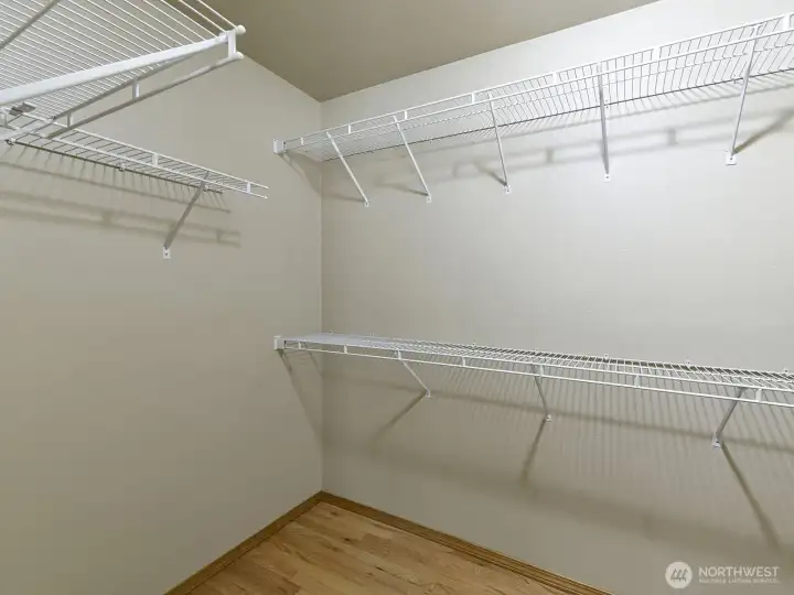 Primary bedroom walk in closet.  LOTS of storage space!