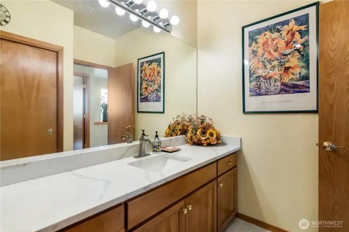 Full main bathroom w/new quartz countertops/backsplash and new tile floors.