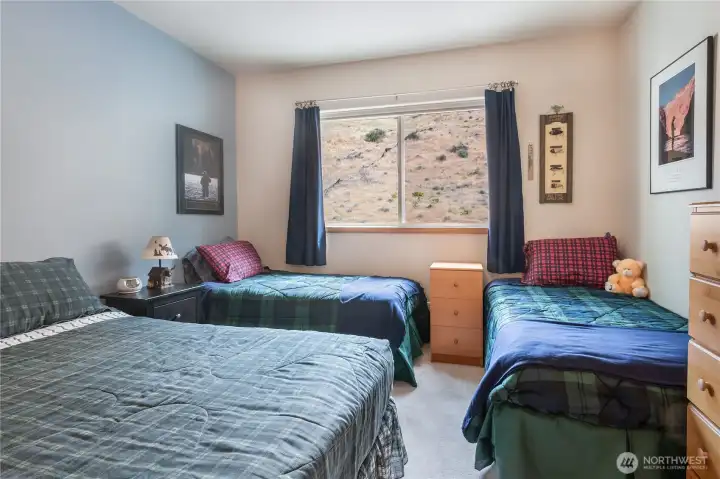 Spacious 3rd bedroom holds a queen & 2 single beds w/views of the Basalt Cliffs.