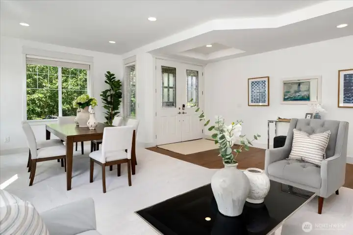 Elegant formal living & dining rooms showcase fresh interior paint, plush new carpeting, rich hardwood floors, and abundant natural light, creating an inviting setting for sophisticated entertaining.