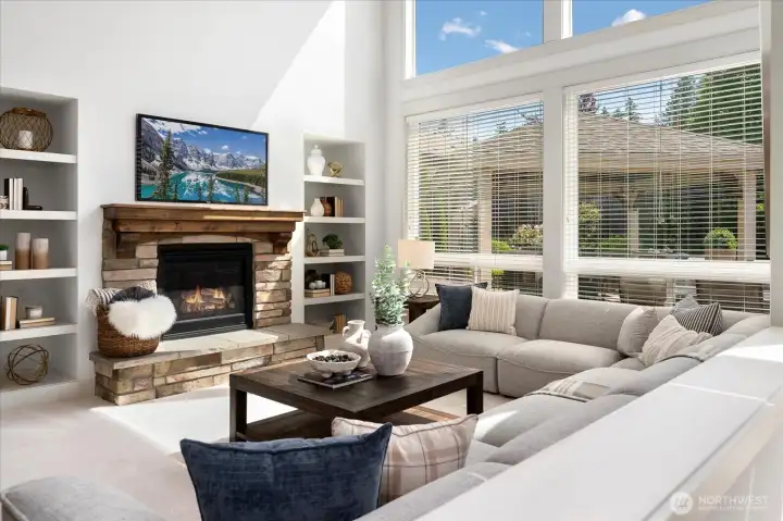 Anchored by a stunning stone gas fireplace and custom built-ins, the family room offers an inviting retreat where warmth, timeless craftsmanship, and everyday comfort come together beautifully.