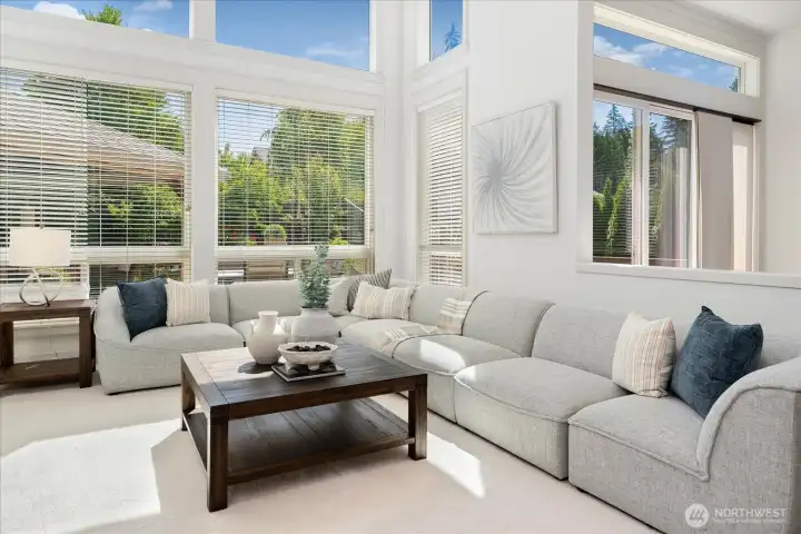 Sunlight pours into this beautifully refreshed family room, where fresh interior paint, luxurious new carpeting, and expansive windows overlooking the private backyard create a warm, elegant space to relax and reconnect.