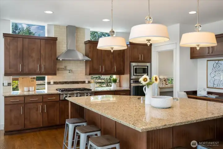 Beyond the impressive oversized square island, the chef's kitchen offers a spacious walk-in pantry and a thoughtfully designed workstation, creating a space that's both beautifully appointed and exceptionally functional.