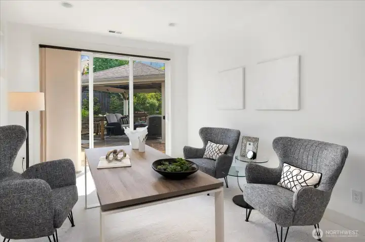 This inviting main-level office has been beautifully refreshed with fresh paint and new carpeting, while sliding glass doors provide easy access to the private backyard and outdoor entertaining areas.