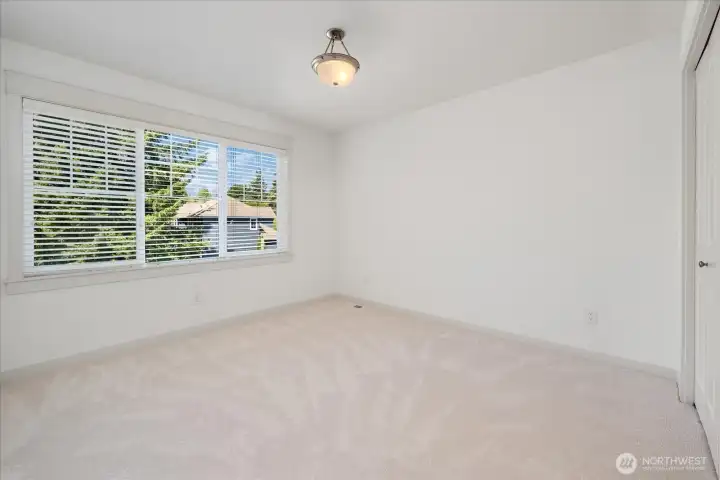 Bedroom #4 Perfect for guests or multigenerational living, this spacious bedroom offers a private ensuite, generous closet, fresh paint, new carpet, and abundant natural light.