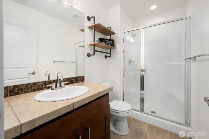 Bedroom #4 offers the luxury of its own private ensuite, featuring a walk-in shower, stylish vanity, and elegant finishes that provide comfort and privacy for family or guests.