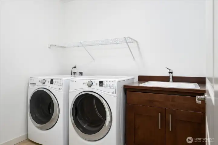 Conveniently located on the second level, the spacious laundry room features a utility sink, abundant storage, and the washer and dryer are included—making everyday living effortless.