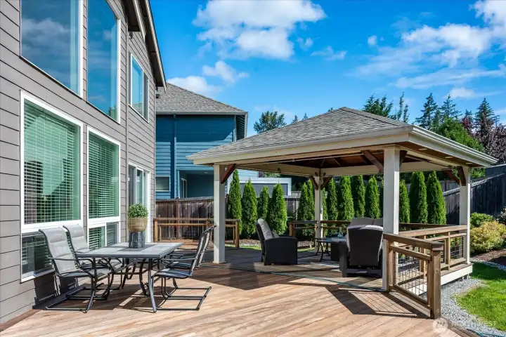 Whether hosting dinner with friends or enjoying a quiet morning coffee, this inviting outdoor dining space offers a beautiful connection to the thoughtfully landscaped backyard and effortless indoor-outdoor living.