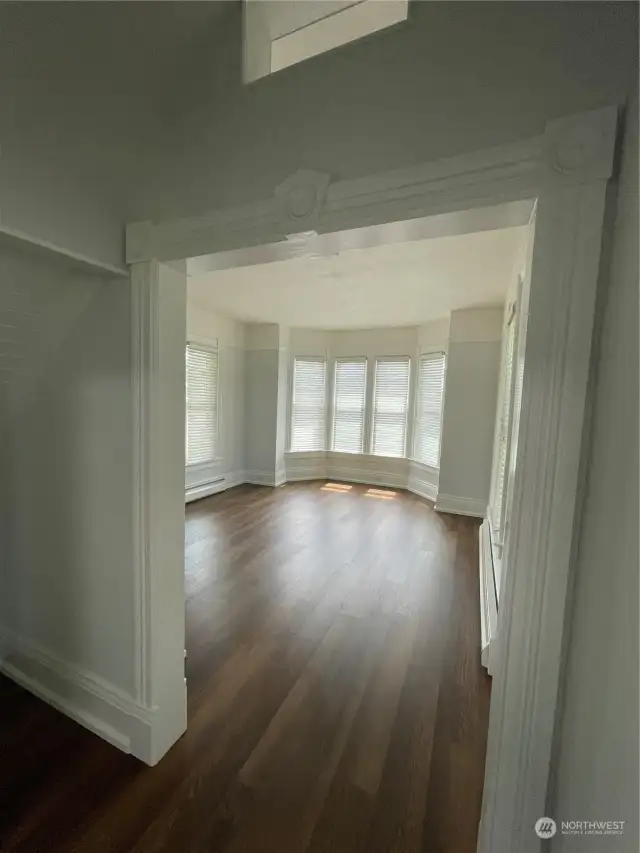 Another view of Living Rm from Formal Dining Rm.. Gorgeous Bay Window Lots of Millwork Detailing.