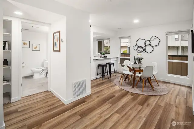 Hallway to full bath + primary bedroom.