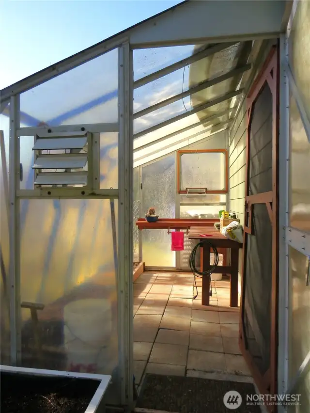 There is also a greenhouse in the backyard!