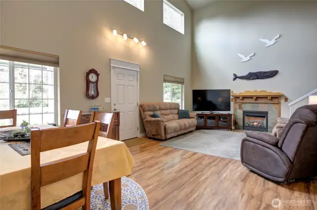 Vaulted ceilings, clerestory windows and stone fireplace are homey features of the living space.
