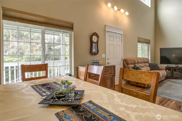 The dinning room overlooks the beautiful front deck and woody area.