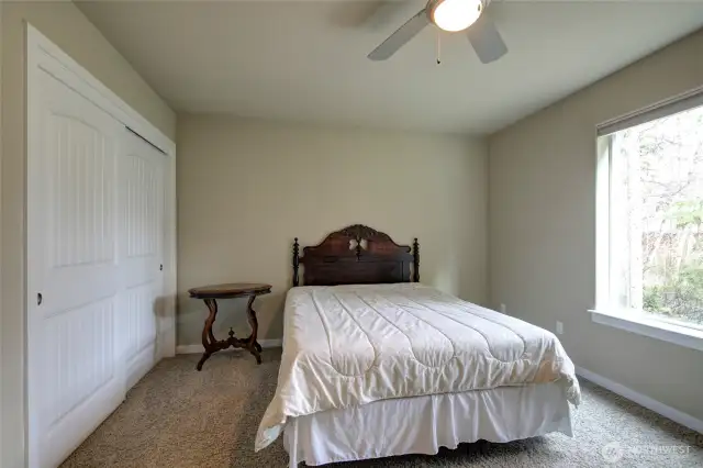 A generously sized closet opposite the window.