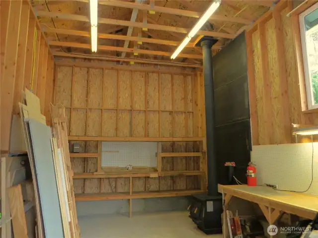 Looking inside the RV shop, you will find storage and a wood burning stove.